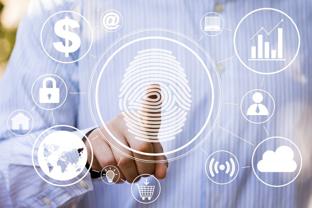 Businessman pressing modern technology panel with fingerprint print