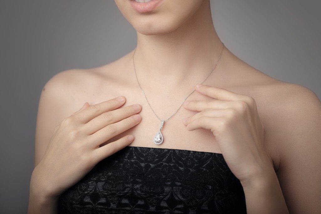woman showing her diamond necklace