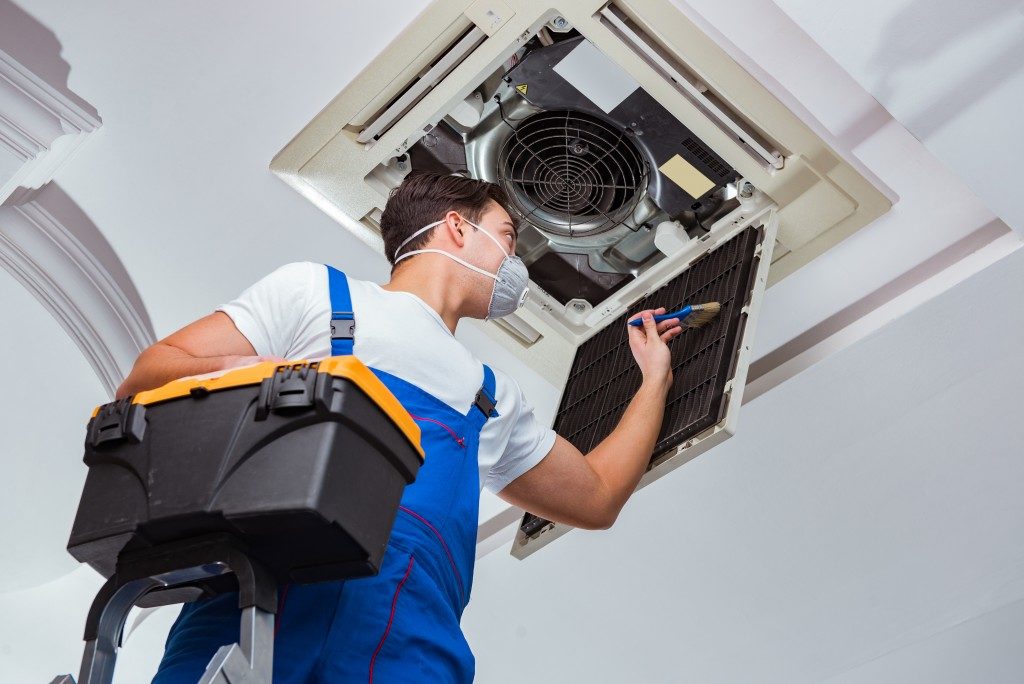 professional cleaner cleaning an hvac