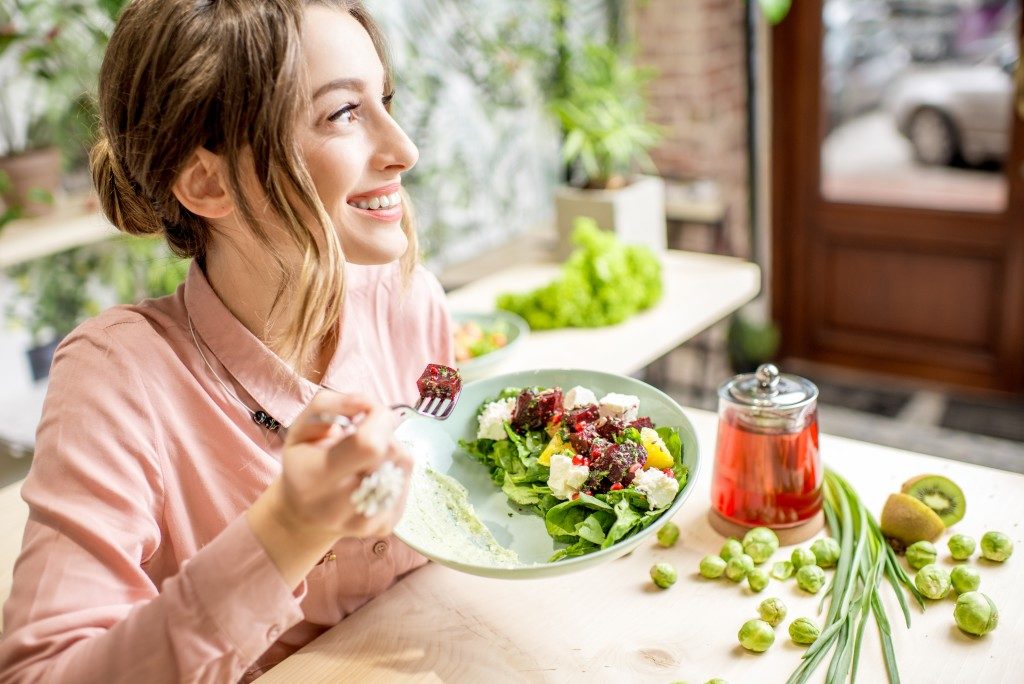 woman eating a vegan salad