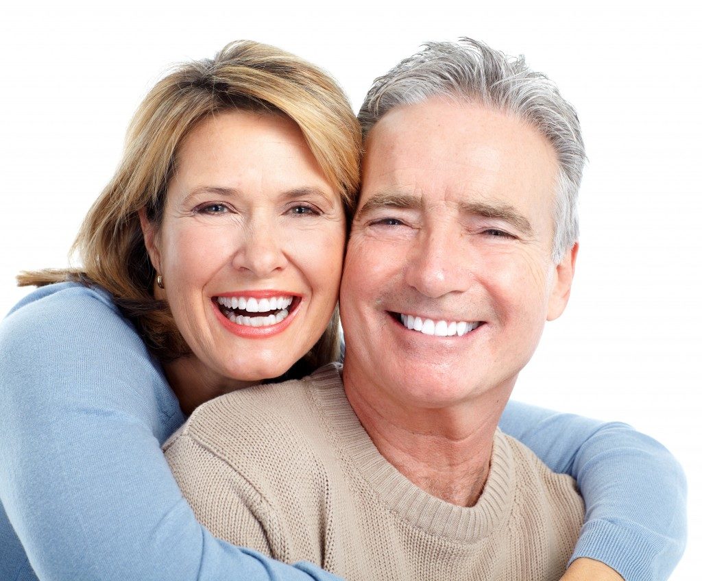Senior smiling couple over white background
