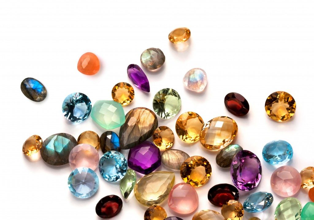 Collection of many different natural gemstones on the white background