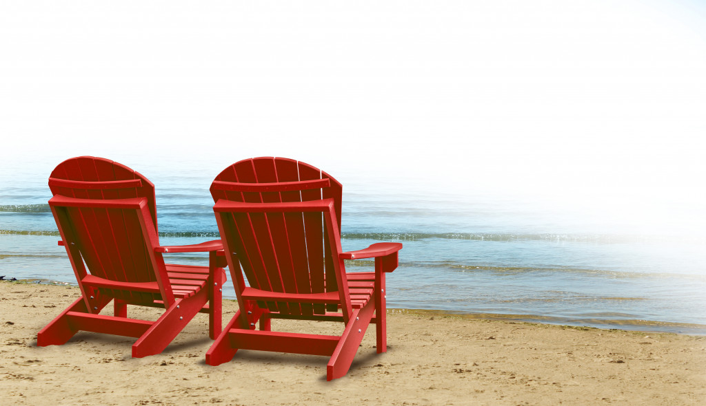 two red beach chairs by the shore