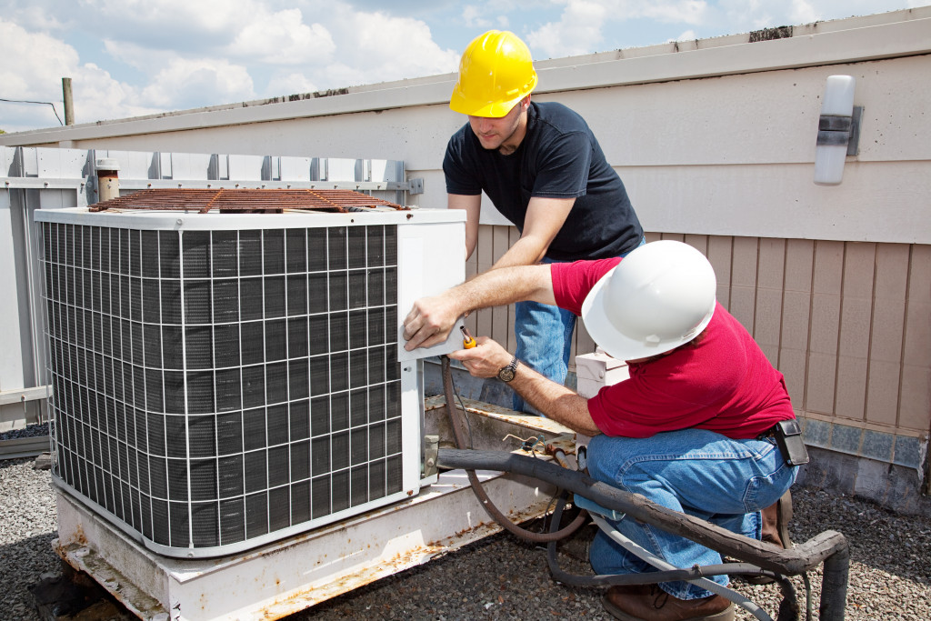 Men working on the ventilation system of a building