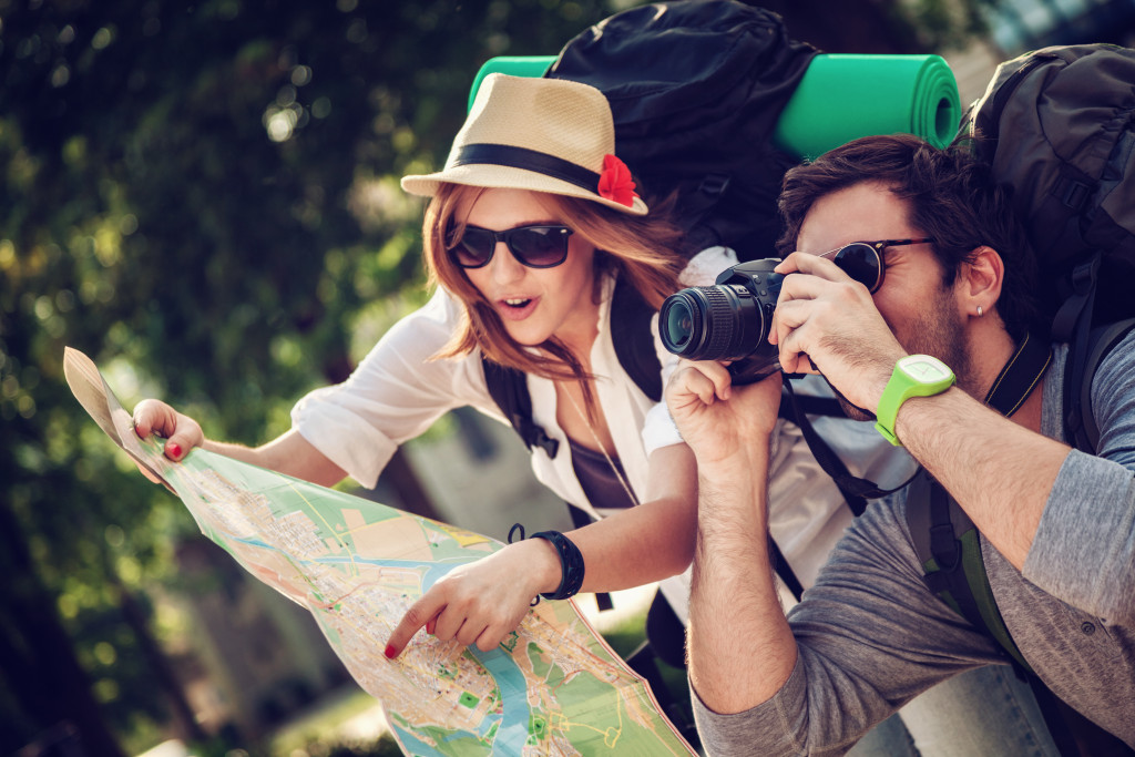 couple traveling checking map for tour