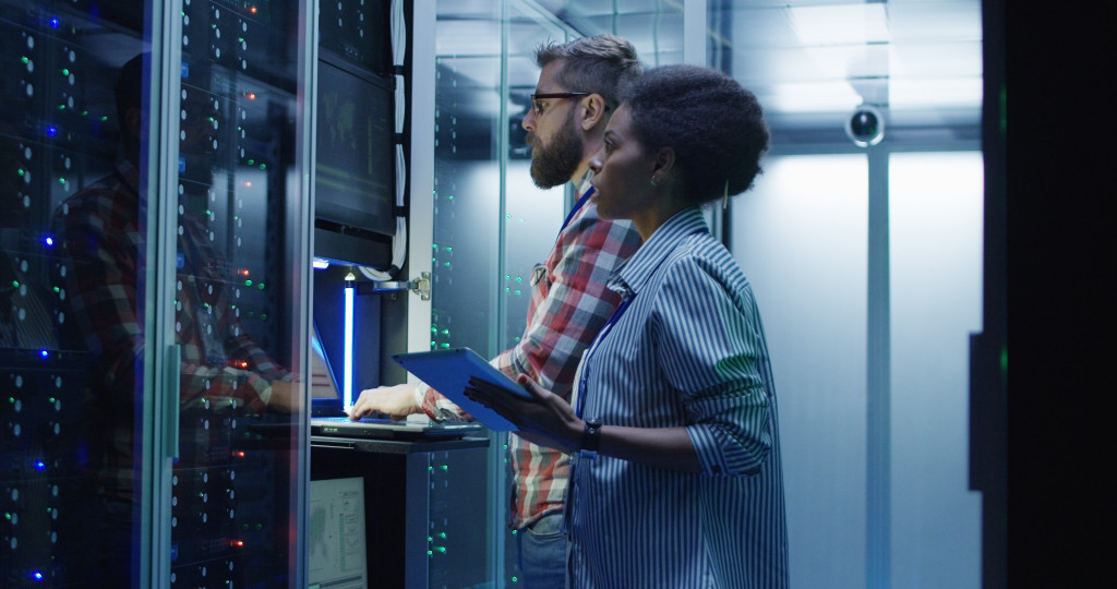 a man and a woman checks the server room