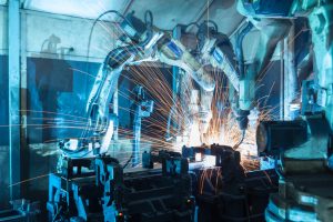 Welding robots used to manufacturing auto parts in a factory.