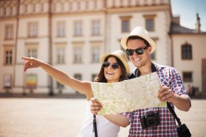 happy couple using a map while traveling